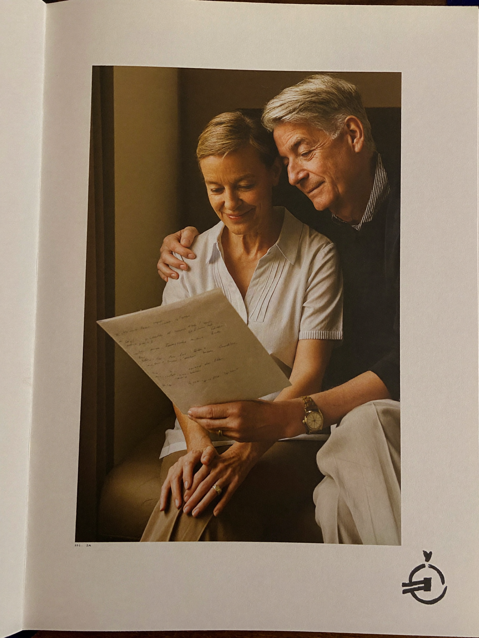 Senior couple sitting together at home reviewing a document